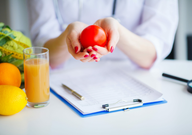 Diet. Doctor Nutritionist hold tomato in her office. Concept of natural food and healthy lifestyle. Fitness and healthy food diet concept. Balanced diet with vegetables.
