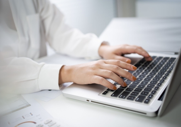 Woman working by using a laptop computer Hands typing on keyboard. writing a blog. Working at home are in hand finger typewriter.