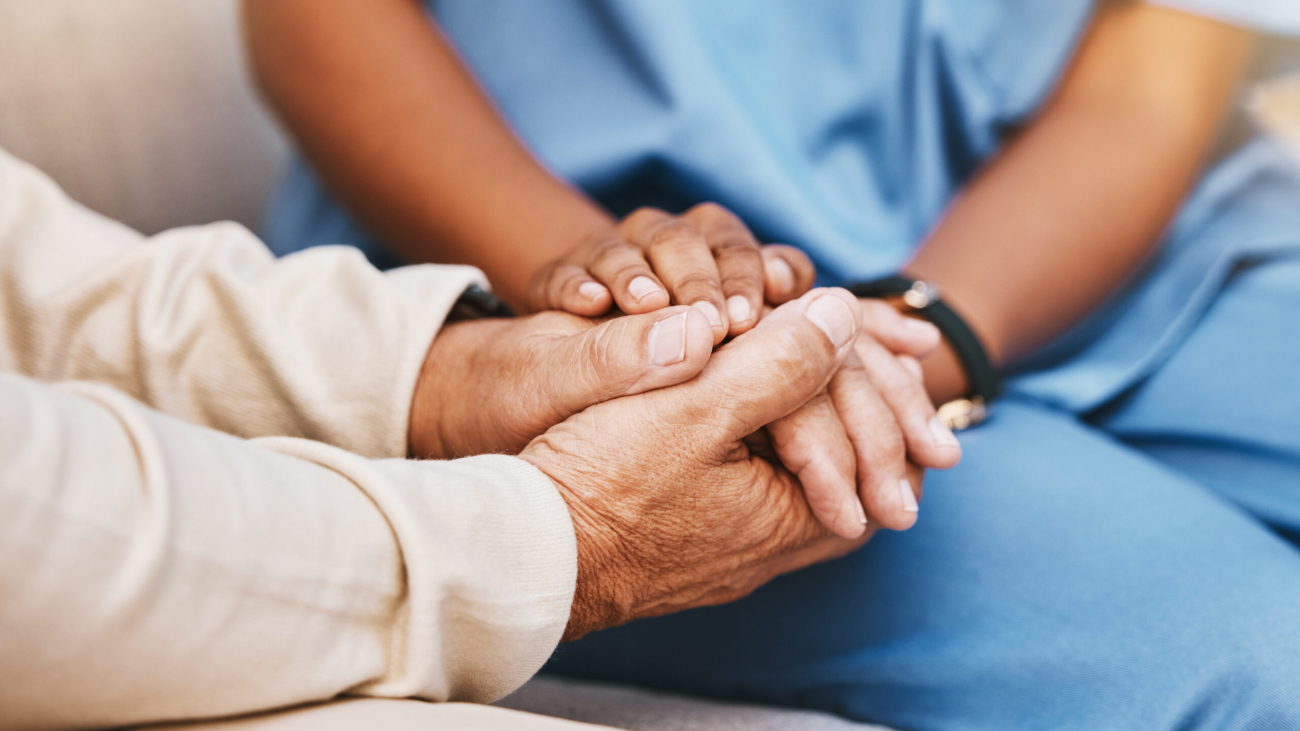 Nurse, patient and holding hands in nursing home for healthcare, empathy and support in depression, anxiety and psychology. Medical counseling, therapy and caregiver with hope, advice and counseling.